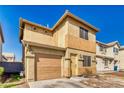 Two-story home with an attached garage, showcasing a well-manicured lawn and inviting front entrance at 5179 Floralita St, Las Vegas, NV 89122