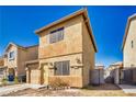 Cozy two-story home with tan stucco, attached garage, and low-maintenance yard at 5179 Floralita St, Las Vegas, NV 89122