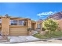 Charming home featuring a two-car garage, second story balcony, landscaped yard, and beautiful desert landscaping at 536 Greenbriar Pl, Boulder City, NV 89005