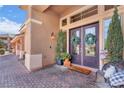 Charming entryway adorned with wreaths and potted plants, leading to a welcoming front door at 5868 Revital Ct, Las Vegas, NV 89131