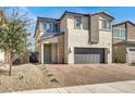 Inviting home with desert landscaping, brick driveway, and a spacious two-car garage at 6618 Palm Branch St, North Las Vegas, NV 89086