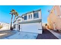 Inviting two-story home featuring a two-car garage, tiled roof, and palm trees in the front yard at 7244 Buglehorn St, Las Vegas, NV 89131