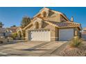 Exterior of a two-story home showing a three car garage, tile roof, and well-maintained desert landscaping at 9532 Cliff View Way, Las Vegas, NV 89117