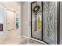 Inviting entryway features decorative glass door and sidelight with views into the home's open layout at 10438 Skye Arroyo Ave, Las Vegas, NV 89166
