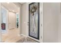 Inviting entryway features decorative glass door and sidelight with views into the home's open layout at 10438 Skye Arroyo Ave, Las Vegas, NV 89166