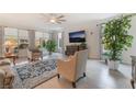 Bright living room with large windows, neutral decor, and wood-look flooring, perfect for entertaining at 10438 Skye Arroyo Ave, Las Vegas, NV 89166