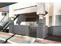 Exterior view of condo with a gated front porch and adjacent exterior staircase at 1316 Driscoll Dr # 102, Las Vegas, NV 89128