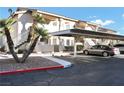 Condo exterior with covered parking, a private entrance, and mature landscaping at 1316 Driscoll Dr # 102, Las Vegas, NV 89128
