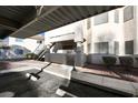 Condo exterior view showcasing a private gated porch and nearby exterior staircase at 1316 Driscoll Dr # 102, Las Vegas, NV 89128