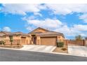Inviting single-Gathering home featuring a well-kept lawn and a driveway leading to a two-car garage at 172 Turtle Ridge Ave, Las Vegas, NV 89183