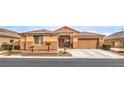 Charming single-story home with a well-manicured lawn and a two-car garage on a sunny day at 172 Turtle Ridge Ave, Las Vegas, NV 89183