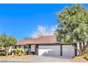 Single story home featuring mature trees, a driveway, and a two car garage at 1942 Hallwood Dr, Las Vegas, NV 89119