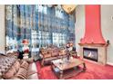 Elegant living room with fireplace, crystal chandelier, and classic furniture arrangement at 2212 Barton Mill Ct, North Las Vegas, NV 89084