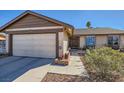 Delightful single-story home featuring a two-car garage and a well-maintained front yard with mature shrubbery at 2375 Rawhide St, Las Vegas, NV 89119