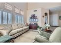 Elegant living room with high ceilings, large windows, and comfortable seating at 2529 Vera Cruz Cir, Henderson, NV 89074