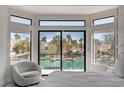 Bedroom with beautiful view of canal featuring floor to ceiling windows and a cozy chair at 3012 Waterside Cir, Las Vegas, NV 89117