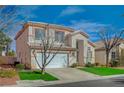 Charming two-story home with a manicured lawn, a two-car garage, and desert landscaping at 316 Blackstone River Ave, Las Vegas, NV 89148
