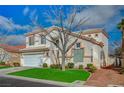 Two-story home with desert landscaping, a two-car garage, and a well-manicured front lawn at 316 Blackstone River Ave, Las Vegas, NV 89148