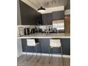 Modern kitchen with stainless steel appliances, sleek cabinetry, and stylish counter seating at 353 E Bonneville Ave # 447, Las Vegas, NV 89101