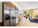Modern kitchen featuring stainless steel appliances, sleek cabinets, and an open layout overlooking living area at 3722 Las Vegas Blvd # 1709, Las Vegas, NV 89158