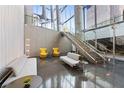 Modern lobby featuring stylish seating, concrete accents, glass walls, and grand staircase at 3722 Las Vegas Blvd # 1709, Las Vegas, NV 89158