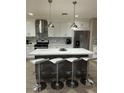 Modern kitchen featuring gray backsplash and large island with marble countertop at 3908 Redwood St, Las Vegas, NV 89103