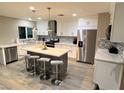 Spacious kitchen featuring a gray island with marble countertops and stainless steel appliances at 3908 Redwood St, Las Vegas, NV 89103