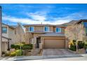 Charming two-story home with a neutral exterior, landscaped front yard, paved driveway, and a two-car garage at 5741 Shadow Bend Dr, Las Vegas, NV 89135