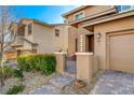 Inviting front entrance with manicured landscaping, brick walkway, and charming gate at 5741 Shadow Bend Dr, Las Vegas, NV 89135