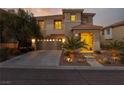 Inviting two-story home with well-manicured front yard, driveway, and attached two-car garage at 575 Lacabana Beach Dr, Las Vegas, NV 89138