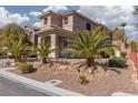 Beautiful two-story home featuring well-kept landscaping and a welcoming covered entryway at 575 Lacabana Beach Dr, Las Vegas, NV 89138