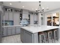 Gorgeous kitchen featuring an oversized island with seating, stainless steel appliances, and stylish backsplash at 575 Lacabana Beach Dr, Las Vegas, NV 89138