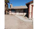 Quaint one story home featuring a stucco facade, a chimney and desert landscaping at 6760 Fallona Ave, Las Vegas, NV 89156