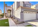 Charming home featuring a well-maintained lawn and a two-car garage with decorative windows at 7267 Sequoia Springs Dr, Las Vegas, NV 89147