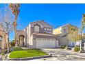 Charming two-story home featuring a well-maintained lawn and a two-car garage in a residential neighborhood at 7267 Sequoia Springs Dr, Las Vegas, NV 89147