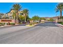 Community entrance gate featuring neatly landscaped bushes and trees at 8 Via Dolcetto, Henderson, NV 89011