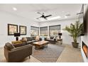 Bright living room with a ceiling fan, skylight, neutral decor, and modern furnishings at 803 Bolide St, Las Vegas, NV 89138