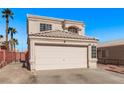 Exterior view of a two-story home with a large two-car garage, xeriscaping, and a neutral-colored exterior at 8068 Cetus Cir, Las Vegas, NV 89128