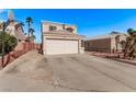 Two-story house featuring xeriscaped landscaping and a spacious driveway with a basketball hoop, under a clear blue sky at 8068 Cetus Cir, Las Vegas, NV 89128