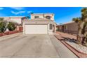 Charming two-story home with a large driveway and low-maintenance landscaping, painted in neutral tones at 8068 Cetus Cir, Las Vegas, NV 89128
