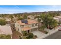 Aerial view of a home showcasing the tile roof, solar panels, landscaping, and the surrounding neighborhood at 820 Sandhill Sage St, Henderson, NV 89052