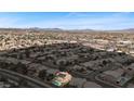 Wide aerial view of a residential area with a glimpse of the mountains in the background at 820 Sandhill Sage St, Henderson, NV 89052