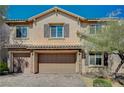 Two-story home with a three-car garage, well-maintained landscaping, and attractive architectural details at 8754 Moon Crater Ave, Las Vegas, NV 89178