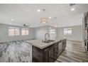 Kitchen with stainless steel sink, granite countertops, and a view of open living spaces at 8754 Moon Crater Ave, Las Vegas, NV 89178