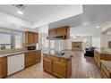 Open kitchen featuring granite countertops, stainless steel appliances, and seamless flow to the living area at 8912 Dio Guardi Dr, Las Vegas, NV 89117