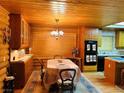Wooden kitchen featuring a rustic chandelier, a large window and modern appliances at , Mount Charleston, NV 89124