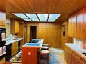 A cozy kitchen with custom cabinets, a skylight, and an island with seating at , Mount Charleston, NV 89124