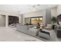 Bright living room featuring modern furnishings, a cozy sectional sofa, and a stylish wine storage unit at 10016 Copper Edge Rd, Las Vegas, NV 89148