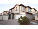 Charming two-story home featuring a two-car garage, desert landscaping, and a covered front entryway at 10596 Corte Sierra St, Las Vegas, NV 89183