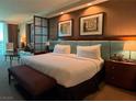 Well-appointed bedroom with a king bed, upholstered headboard, and stylish furnishings with bedside tables at 135 E Harmon Ave # 307, Las Vegas, NV 89109